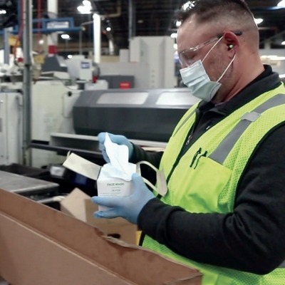 employee packing with mask on